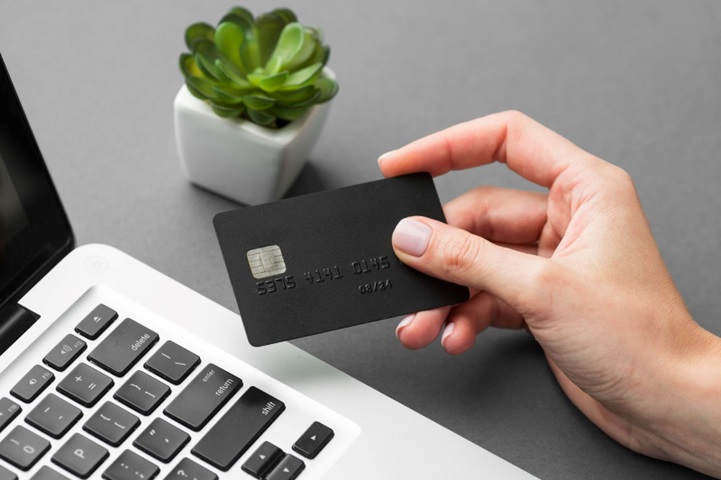 A person is holding a credit card.